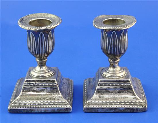 A pair of George III silver dwarf candlesticks, weighted.